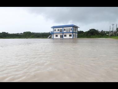 File
The newly built Green Acres Police Station on St John’s Road, Johnson Pen, is swamped by floodwaters. Drainage works are yet to be undertaken to alleviate the flood risk.