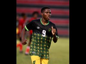 Orane Watson celebrates after scoring Jamaica’s opening goal in their under-17 practice match against Trinidad and Tobago at the Anthony Spaulding Sports Complex today.