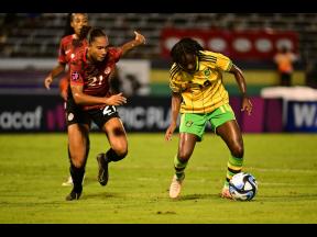 Jamaica’s Jody Brown (right) dribbles past Canada’s Jade Rose during last night’s Concacaf Women’s Olympic Games first leg playoff match at the National Stadium.  Canada won 2-0.