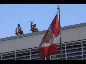 Canadian soldiers stand guard on the rooftop of their embassy in Port-au-Prince, Haiti, on Wednesday, April 10.