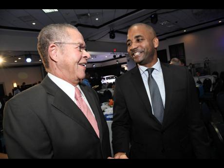 President of the Jamaica Securities Dealers Association and CEO of NCB Capital Markets Limited, Steven Gooden (right), greets former Prime Minister Bruce Golding during day two of the JSE 14th Regional Investments and Capital Markets Conference 2019, at The Jamaica Pegasus hotel in New Kingston on Wednesday, January 23, 2019.