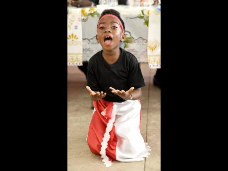 Alliah Johnson performs ‘Child Molester’ at the handover ceremony for a learning centre at Rock River Primary School in Clarendon yesterday. The project, which was funded with a $10 million grant from the Embassy of Japan, is expected to help the school boost its services to the rural Clarendon community.