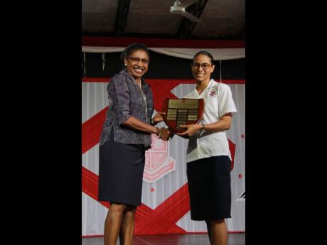 Grace Baston (left), principal, Campion College, presents the top CSEC student, Renee Ann Meeks with the Avinash Polturi trophy and scholarship. Meeks attained 10 grade one passes with straight A profiles in each subject in the 2018 CSEC examinations.