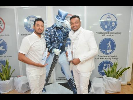 Andrew Anguin (left), Brand Manager for Johnnie Walker at Red Stripe, and Nathan Nelms, Junior Brand Manager for Johnnie Walker at Red Stripe, show off the new Johnnie Walker limited edition scotch, the White Walker.