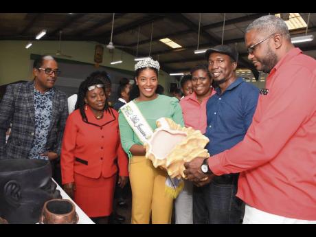 (Fromleft) Dr. Norman Dunn, Member of Parliament for South East St Mary; Mrs Juliet Sadaar, Principal, St Mary High School; Ackera Gowie, Miss Jamaica Festival Queen 2018; Mrs Danielle Harris-Drysdale, Acting Marketing Manager at Lasco Financial Services; Mr Scheed Cole, Founder and Director of 360 Recycle and Mr DemerceGuscot, St Mary 4-H Parish Development Officer take in 'upcycled' items on display at the launch of EcoMoney.  