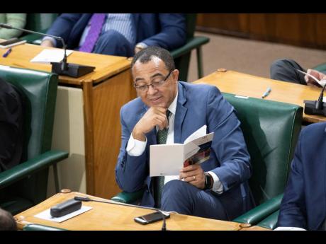 Minister of Health Dr Christopher Tufton follows the Throne Speech being read by Governor General Sir Patrick Allen at the ceremonial opening of Parliament last Thursday.
