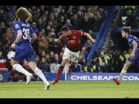 Manchester United’s Ander Herrera (centre) scores the opening goal of the game during the English FA Cup fifth round match  against hosts Chelsea at Stamford Bridge in London, England, yesterday. 
