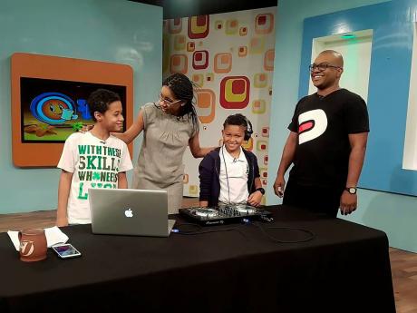 From left: DJ Tzi and Sebastian of the Kidz Mix DJ Club share what they have learnt from DJ Denvo with ‘Smile Jamaica’ host Simone Clarke-Cooper.