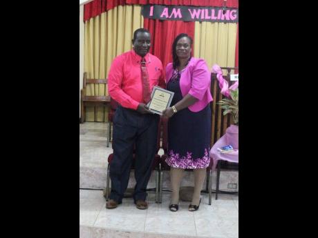 Elder Sharon Morris and Deacon Leroy Morris display their certificate of appreciation that was awarded to them by the congregation at Kitson Town Seventh-day Adentist Church.
