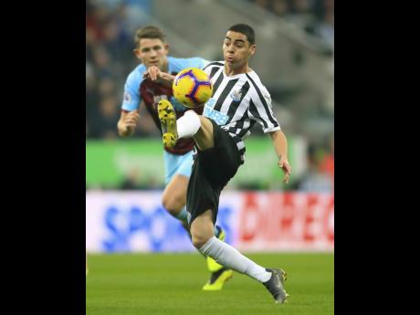 Newcastle United’s Miguel Almiron controls the ball during an English Premier League match against Burnley at St James’ Park in Newcastle, England, yesterday. Newcastle won 2-0.