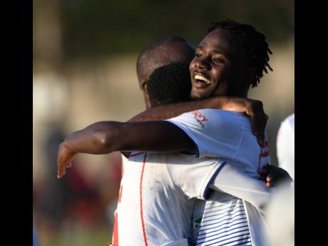 Portmore United’s Andre Lewis (right) is congratulated by team-mates after scoring against Arnett Gardens, in their Red Stripe Premier league encounter at the Spanish Town Prison Oval on Sunday.