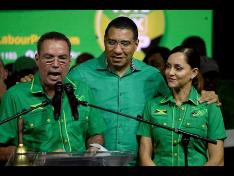 West Portland Member of Parliament Daryl Vaz fires up the crowd at a Jamaica Labour Party campaign rally in Port Antonio last night as JLP leader Andrew Holness and East Portland caretaker Ann-Marie Vaz look on.