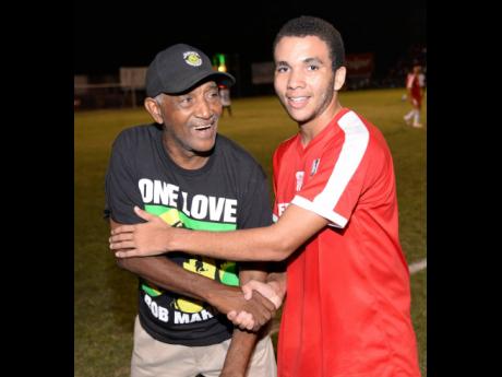 Organiser Clive 'Busy' Campbell (left) and one of Bob Marley's grandsons, Kristian Marley, share a light moment at the Bob Marley One Love football match at Anthony Spaulding Sports Complex in 2016. The charity event returns to the venue this Wednesday.