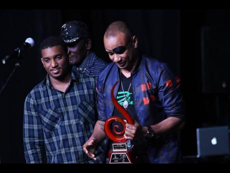 Renaissance Disco principal Delano Thomas Sr (right) receives an award at the recently held Jamaica Reggae Industry Association awards ceremony for his contribution to Jamaican music. Beside him is his son Delano Thomas Jr. 