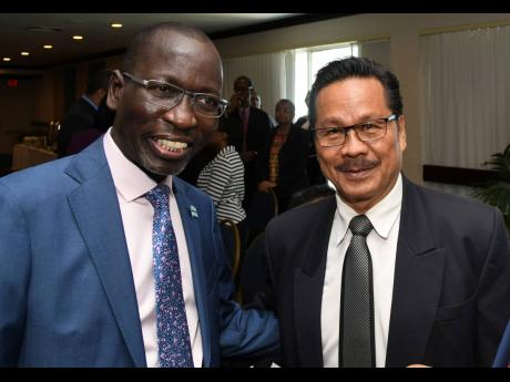 Collen Kelapile (left), Botswana ambassador to Jamaica, and Alfred Palembangan, Indonesian high commissioner, attending the meeting of diplomatic heads at the Ministry of Foreign Affairs and Foreign Trade. The event was held at The Jamaica Pegasus in New Kingston yesterday.
