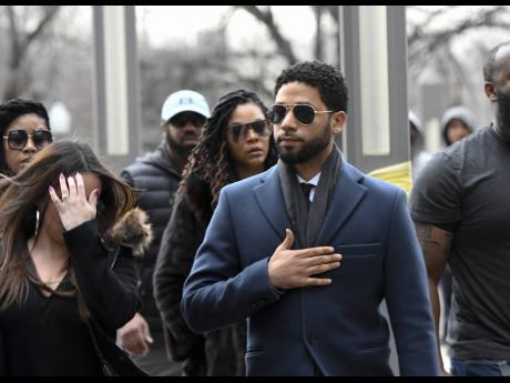 
Empire actor Jussie Smollett, centre, arrives at the Leighton Criminal Court Building for his hearing yesterday, in Chicago. Smollett is accused of lying to police about being the victim of a racist and homophobic attack by two men on Jan. 29 in downtown Chicago. (AP Photo/Matt Marton)