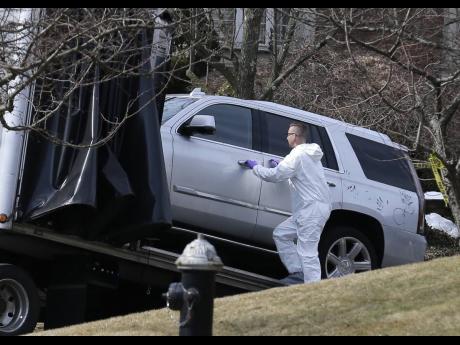 Crime scene investigators load a car that appears to have been checked for fingerprints on to a flatbed truck in the Staten Island borough of New York yesterday.  Francesco ‘Franky Boy’ Cali was found with multiple gunshot wounds at his red-brick, colonial-style house on Staten Island on Wednesday night and was pronounced dead at a hospital.