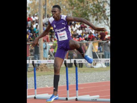 Jayden Brown of Kingston College, clears the final hurdle ahead of the field to win the class two boys 400 metres hurdles during the Digicel Grand Prix final, which was held at G.C. Foster College on Saturday.