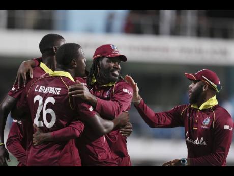 The Windies One-Day International cricket team celebrates beating England by 26 runs in the second One Day International cricket match at the Kensington Oval in Bridgetown, Barbados, on Friday, February 22, 2019. 