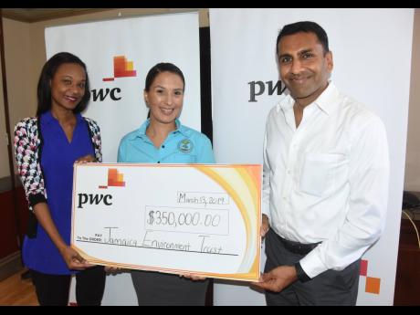 Gail Moore (left), environment lead partner and Alok Jain, regional advisory leader,
PwC Jamaica, present a cheque for $350,000 to Suzanne Stanley, CEO of the Jamaica Environment Trust.