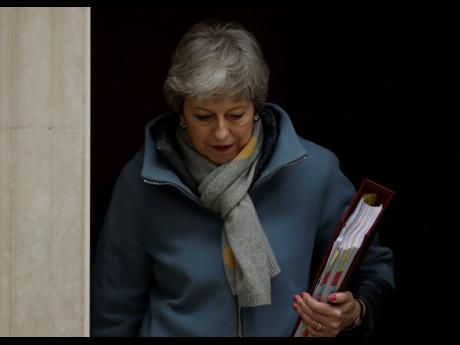 Prime Minister of the United Kingdom Theresa May leaves 10 Downing Street to attend the weekly Prime Ministers’ Questions session at Parliament in London, on Wednesday, March 20.