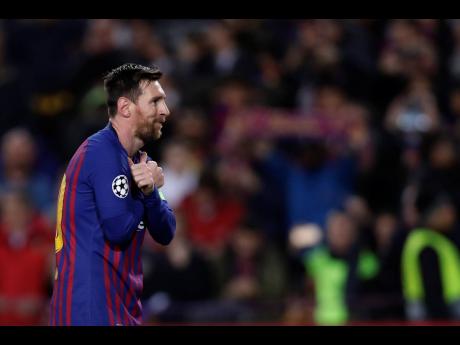 Barcelona forward Lionel Messi celebrates after scoring his team’s opening goal from the penalty spot during the Champions League round of 16, second leg match between FC Barcelona and Olympique Lyon at the Camp Nou stadium in Barcelona, Spain on Wednesday, March 13.