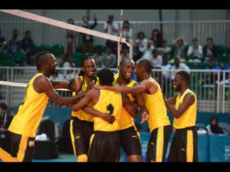 Members of the Special Olympics Jamaica volleyball team celebrate after defeating Japan  by two sets to one to capture the gold medal in the event at the Special Olympics World Summer Games in Abu Dhabi, United Arab Emirates, on Wednesday.  COLLIN REID PHOTO COURTESY OF ALLIANCE INVESTMENTS, DIGICEL FOUNDATION, KFC AND MINISTRY OF SPORTS