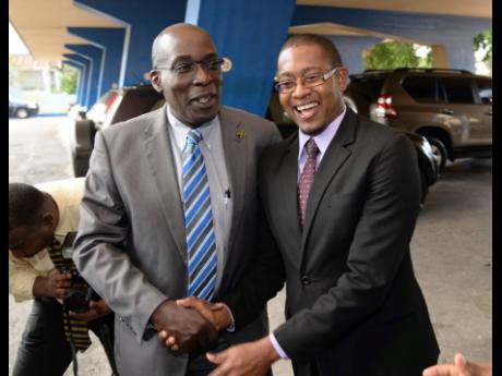 Then Minister of Education Ruel Reid and his state minister, Floyd Green, are jovial as they take up their posts on March 8, 2016. Weeks before Reid’s sacking, Green was reassigned to the Ministry of Industry, Commerce, Agriculture and Fisheries. 