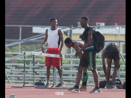 Calabar High athletes, including Class One sprint star and team captain Christopher Taylor (left), at a training session on the  school grounds yesterday. 