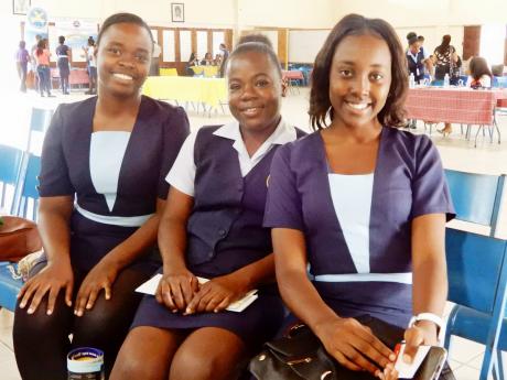 Students of the Moneague College School of Humanities, (from left), Vanessa Alexander, Tedeisha Graham and Savina Wallace take time out from the social-work symposium for a photo opportunity.   