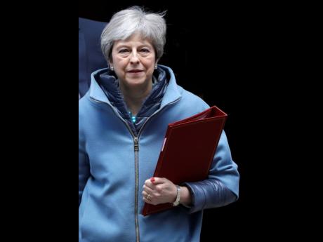 Britain's Prime Minister Theresa May leaves 10 Downing Street in London, Monday, March 25, 2019. The embattled Prime Minister was scrambling Sunday to win over adversaries to her Brexit withdrawal plan as key Cabinet ministers denied media reports that they were plotting to oust her. 