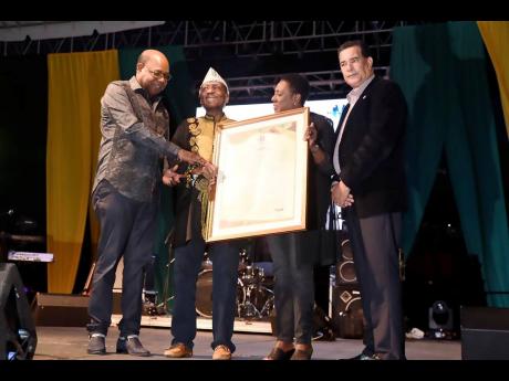 James ‘Jimmy Cliff’ Chambers (second left) being presented with a citation by Minister of Tourism Edmund Bartlett (left) and Minister of Culture, Gender, Entertainment and Sport Olivia Grange. Joining in the moment is Mayor of Montego Bay Homer Davis.