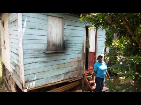 June Gardner, sister of slain taxi operator Robert Gardner, shows the house where her brother and his common-law wife, Marcia Thomas, were killed on Thursday night.
