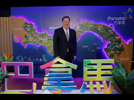 Panama President Juan Carlos Varela Rodríguez poses for photographers before a conference on the Panama invest in Hong Kong, Tuesday, April 2, 2019. 
