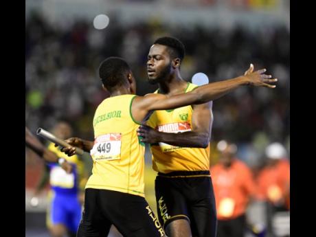 Excelsior’s Travis Williams (right) celebrates with teammate Demar Francis after anchoring his team to the gold medal in the 4x400m relay Open final at the ISSA/GraceKennedy Boys and Girls’ Athletics Championships at the National Stadium last Saturday. 