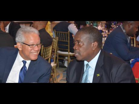 Robert Montague (right), minister of transport and mining, engaged in conversation with Rear Admiral (Ret’d) Peter Brady, director general of the Maritime Authority of Jamaica, at the last International Bunker Industry Association workshop and conference, held in Montego Bay.