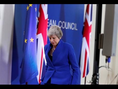 British Prime Minister Theresa May leaves the podium after addressing a media conference at the conclusion of an EU summit in Brussels on Thursday, April 11. 