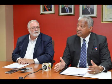 Nari Williams-Singh (right), director general of the Jamaica Civil Aviation Authority (JCAA), makes a point during a press conference on Thursday. Looking on is Phillip Henriques, chairman of the JCAA. 