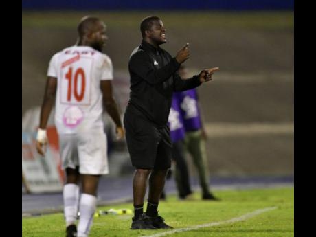 Portmore United head coach Shavar Thomas (right) shouts instructions to his players during their second-leg Red Stripe Premier League semi-final against Mount Pleasant at the National Stadium on Monday. The game ended 1-1 with Portmore progressing 3-2 on aggregate after a 2-1 first-leg win last week Monday at the same venue.