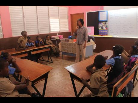 Nordia Anderson- Wallace, teacher, Campbell&apos;s Castle Primary School interacts with students.