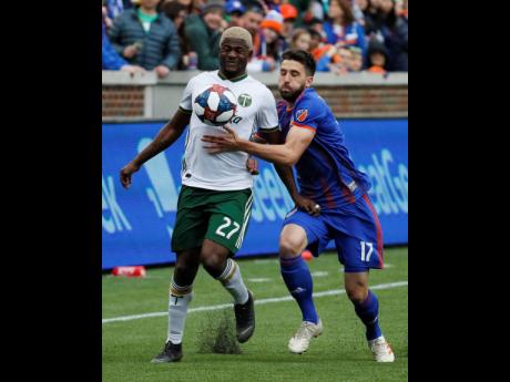 Portland Timbers forward Dairon Asprilla (left) and FC Cincinnati defender Mathieu Deplagne vie for the ball in the first half of an MLS match on Sunday, March 17, in Cincinnati. 
