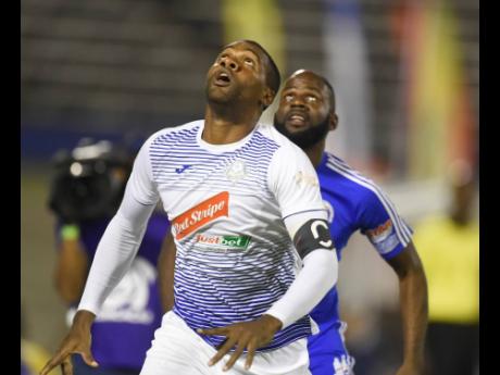 Portmore United captain Rosario Harriott (front) in action against Mount Pleasant FA during their second-leg Red Stripe Premier League semi-final, played at the National Stadium in Kingston on Monday, April 15. 