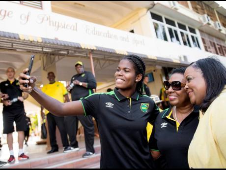 (From left) National striker Khadija &apos;Bunny&apos; Shaw, Minister of Culture, Gender, Entertainment and Sport Olivia Grange and Opposition spokesperson on sports Natalie Neita share a selfie during the Reggae Girlz FIFA World Cup qualification celebration in December 2018.