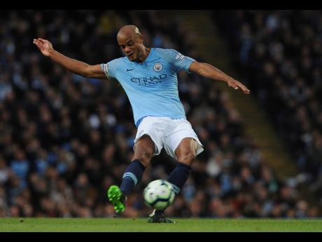 Manchester City’s Vincent Kompany smashes the ball into the net from a distance, giving his team a crucial 1-0 victory over Leicester City in the English Premier League at the Etihad Stadium in Manchester, England, yesterday. The win ensures that the winners of the title will be decided on Sunday’s final day. 