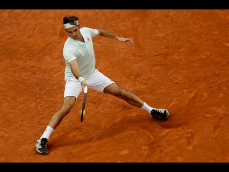 Roger Federer returns the ball to Richard Gasquet during the Madrid Open tennis tournament in Madrid, yesterday. 