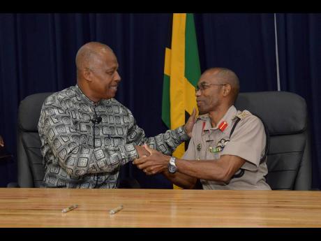 Professor Sir Hilary Beckles (left) greets Lieutentant General Rocky Meade during the MoU signing ceremony between the Caribbean Military Academy and The University of the West Indies at Up Park Camp on Tuesday, May 7. 