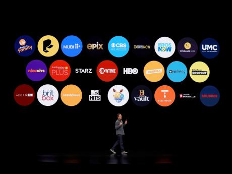 In this March 25, 2019, file photo Peter Stern, Apple Vice President of Services, speaks at the Steve Jobs Theatre against the backdrop of a display of apps. Apple has more than 2 million apps in its App Store.