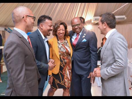 Minister of Tourism Edmund Bartlett (second right) and (from left) Gabriel Heron, vice-president of marketing, JAMPRO; Parris Jordan, CHICOS chairman; Diane Edwards, president, JAMPRO; and Fernando Fernandez, vice-president of development, Apple Leisure Group, share a joyous moment after the recent launch of the Caribbean Hotel Investment Conference and Operations Summit in Kingston.