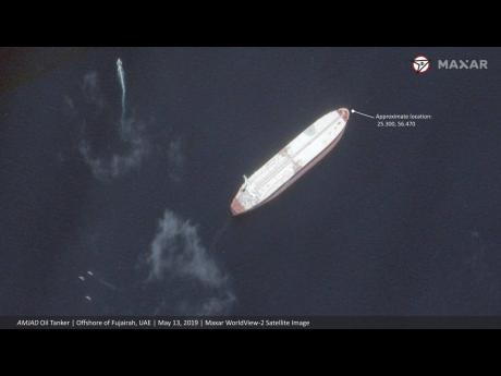 This satellite image provided by Maxar Technologies shows the Saudi-flagged oil tanker Amjad off the coast of Fujairah, United Arab Emirates, Monday, May 13, 2019. As many as four oil tankers anchored in the Mideast were damaged in what Gulf officials described Monday as a "sabotage" attack off the coast of the United Arab Emirates. (Satellite image ©2019 Maxar Technologies via AP)