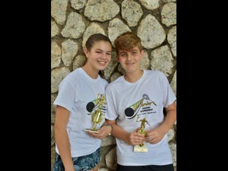 All-Jamaica Under-15/17 girls’ champion Savannah Thomson (left) and All-Jamaica Under-15 boys’ champion Tobias Levy pose with their trophies after winning their respective age groups at the Tingrinners Age Group Squash Tournament, which was held recently at the Liguanea Club in Kingston. Both Thomson and Levy are undefeated in age-group tournaments so far this year. 